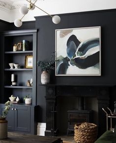 a living room filled with furniture and a painting on the wall over a fire place