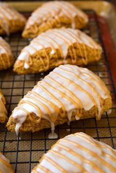 there are many cookies with icing on the cooling rack in front of each other