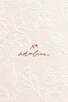 the word adelina written in red ink on a white background with floral designs