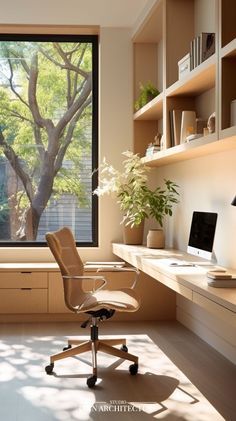 an office with a desk, chair and large window overlooking the trees outside is shown in this image