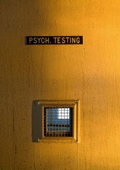 there is a sign on the wall that says psych testing in front of a window