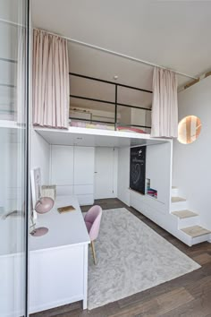 a loft bed with stairs leading up to the top floor and a desk in front of it