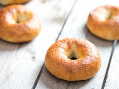 four bagels sitting on top of a wooden table