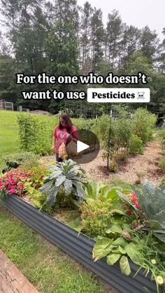 a woman standing in front of a garden filled with lots of plants and flowers, next to a sign that says for the one who doesn't want to use pesticides