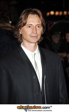 a man in a black suit and white shirt