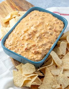 a bowl of dip surrounded by tortilla chips