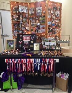 the table is covered with ribbons and medals for all kinds of sports teams, including basketball