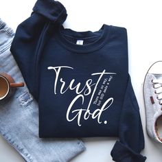 . "Wear your faith proudly with this 'Trust God' Christian Sweatshirt. A beautiful reminder to lean on Him in all circumstances, this Religious Shirt is perfect for expressing your devotion and spreading positivity. This comfortable and stylish Faith Sweatshirt is a must-have for any believer's wardrobe." Ideal for any situation, a unisex heavy blend crewneck sweatshirt is pure comfort. These garments are made from polyester and cotton. This combination helps designs come out looking fresh and b But God Shirt, Christian Sweatshirt Designs, Motivational Clothing, Christian Sweatshirts, Faith Sweatshirt, Sweatshirt Ideas, T Shirt Quotes, Powerful Messages, Shirt Quotes