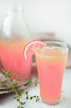 two glasses filled with pink lemonade and garnish