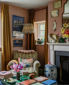 a living room filled with furniture and a fire place next to a window covered in curtains