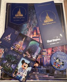 some disney world merchandise is laying out on the floor in front of a castle and other items