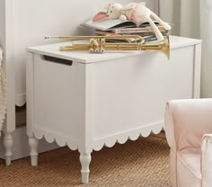 a white table with a trumpet and stuffed animals on it's legs next to a pink chair