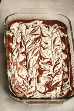 a glass baking dish filled with chocolate and marshmallows