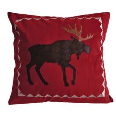 a red pillow with an embroidered moose on it