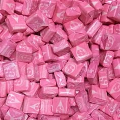 pink candy cubes are stacked on top of each other