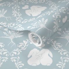 a blue wallpaper with white flowers and leaves on it's sides, as well as a light blue background