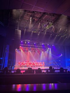 the stage is lit up with purple and blue lights