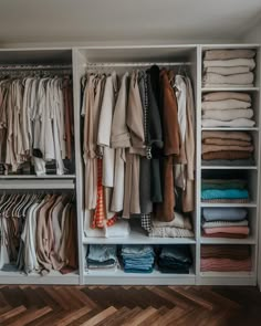 an organized closet with clothes and folded shirts