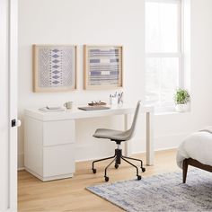 a bedroom with a bed, desk and chair next to a window in the room