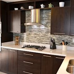 a kitchen with brown cabinets and white counter tops