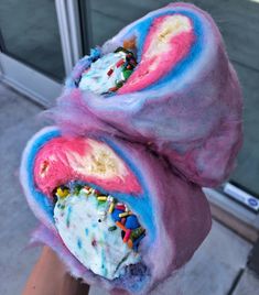 two ice cream cones covered in sprinkles and frosted with icing