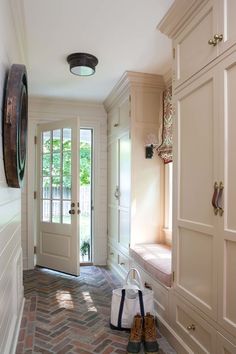 a pair of shoes sitting on the ground in front of a door and some doors