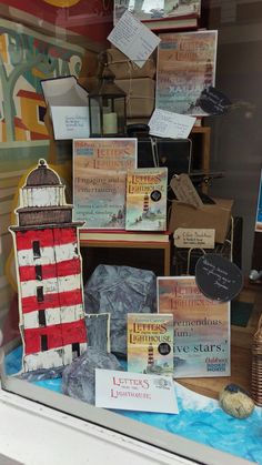 there is a display in the window with books about lighthouses and other things on it