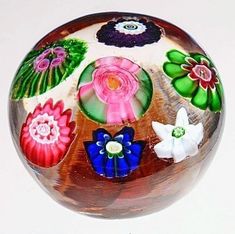 a glass ball with flowers painted on it