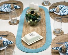 a table with placemats, napkins and glassware on top of it