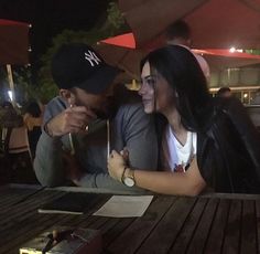 a man and woman sitting at a table together