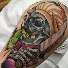 a man with a skull tattoo on his arm