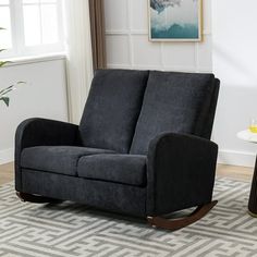 a living room with a black rocking chair