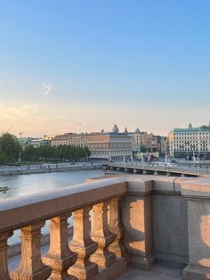 a bridge over water with buildings in the background