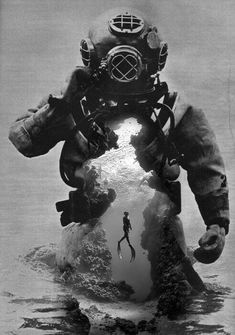 an old black and white photo of a scuba diver