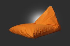 an orange bean bag sitting on top of a black background