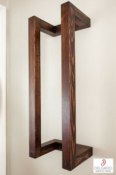 a wooden shelf sitting on top of a white wall