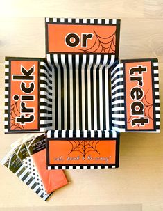 three halloween treat boxes with trick or treat on them and candy in the bottom one