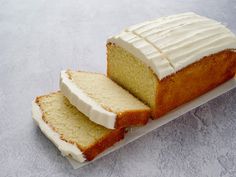 two slices of cake sitting on top of a white platter with frosted icing