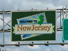 a welcome to new jersey sign with a green street sign below it that says welcome to new jersey