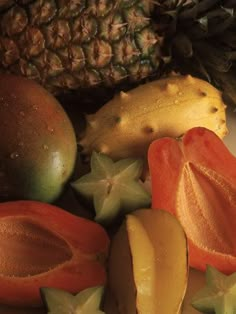 there are many different fruits on the plate and one is cut up to look like star fruit