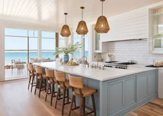 a kitchen with an island and lots of stools in front of the counter top