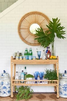 a bamboo shelf with plants and bottles on it