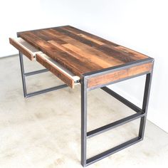 a table made out of wood and metal with two drawers on each side, sitting in a room