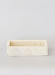 a white marble pen holder sitting on top of a table