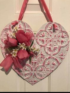 a heart shaped door hanger with flowers on it