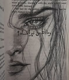 an open book with a drawing of a woman's face and words on it