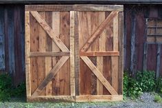 two wooden doors are open on the side of a building