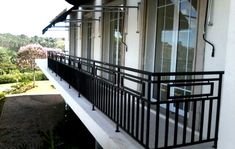 a balcony with wrought iron railings and windows