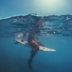 a man riding a surfboard under water