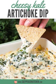 a tortilla chip being dipped with cheese and spinach artichoke dip